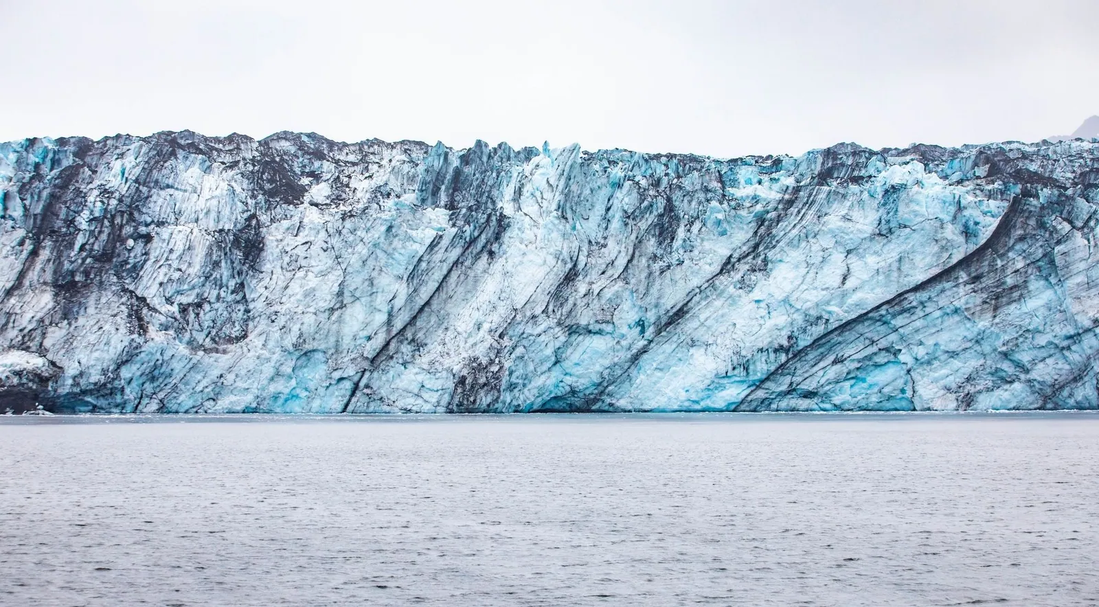 A blue and grey glacier ice wall in winter